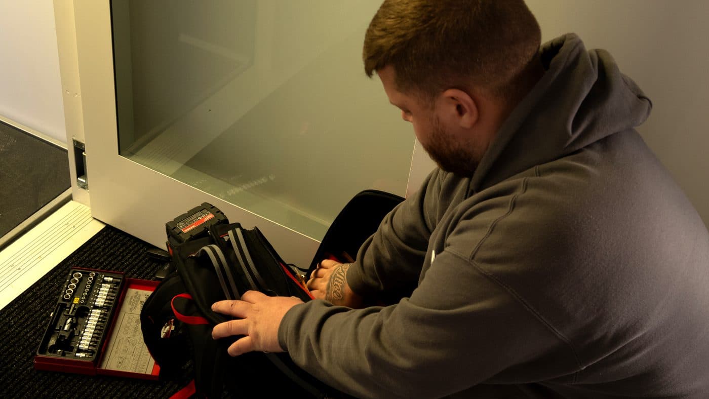 Reed Lifts engineer working on a lift controller